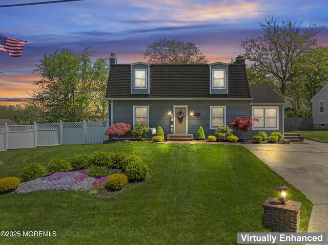 view of front of home with a shingled roof, fence, and a chimney
