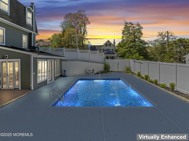 view of pool featuring a patio, a fenced backyard, and a fenced in pool