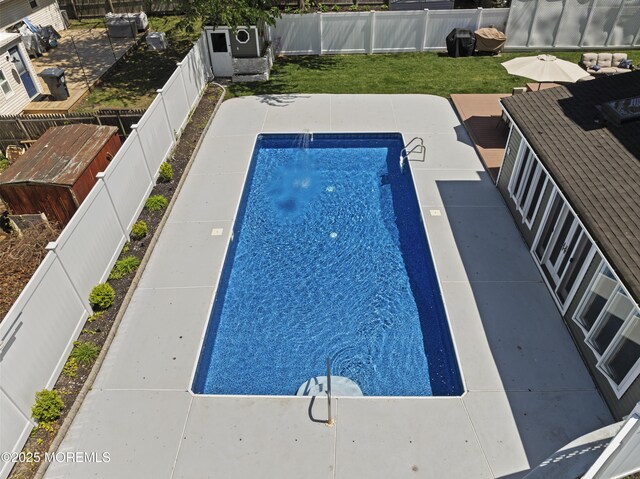 view of swimming pool featuring a fenced backyard, a fenced in pool, and a yard