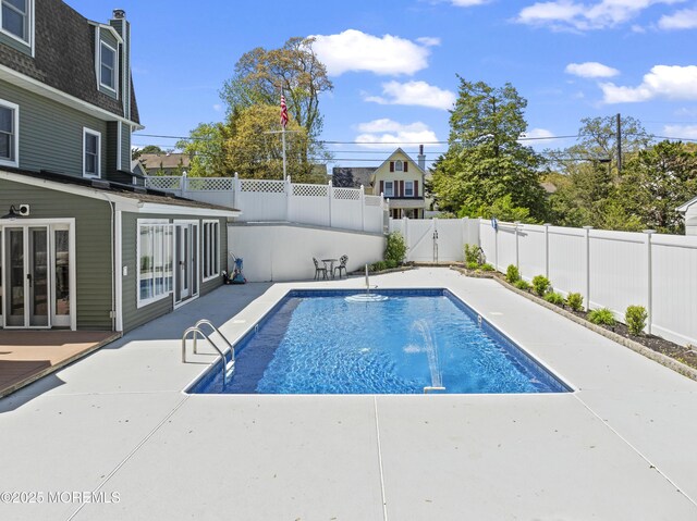 view of pool with a patio, a fenced backyard, and a fenced in pool