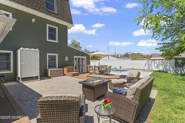 view of patio / terrace featuring outdoor lounge area, outdoor dining space, a fenced backyard, and a fenced in pool