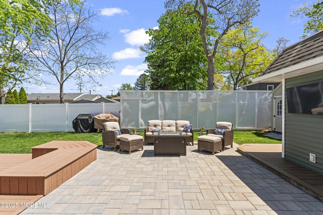 view of patio featuring outdoor lounge area, a wooden deck, and a fenced backyard