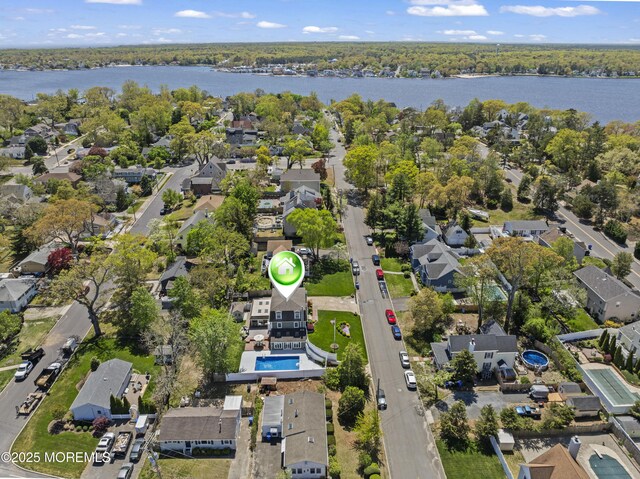 birds eye view of property with a water view and a residential view