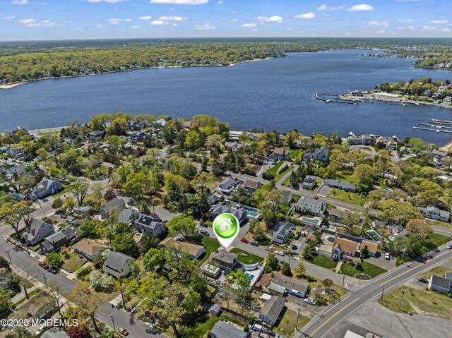birds eye view of property with a residential view and a water view