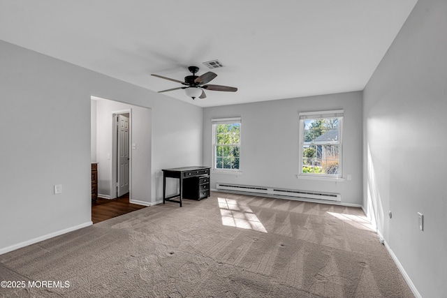 interior space with ceiling fan, baseboard heating, carpet floors, baseboards, and visible vents