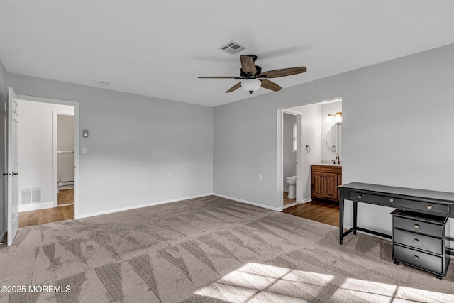 unfurnished bedroom with carpet floors, baseboards, and visible vents