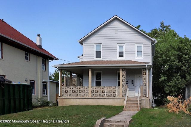 154 Ridge Ave, Asbury Park, NJ 07712 - view of front of house with a porch and a front lawn