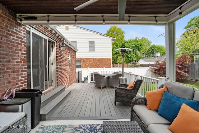 deck featuring fence, an outdoor hangout area, and outdoor dining space