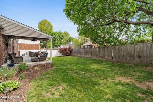 view of yard featuring a fenced backyard, ceiling fan, a patio area, and outdoor lounge area