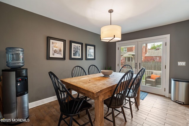 dining room with baseboards, french doors, and wood finished floors