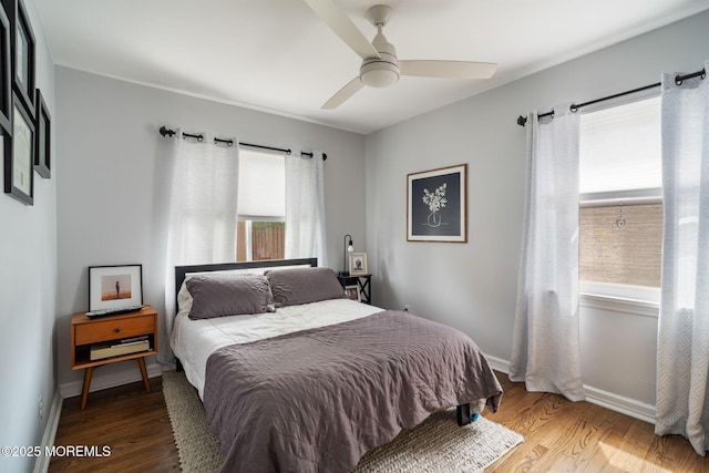bedroom featuring baseboards, ceiling fan, and wood finished floors
