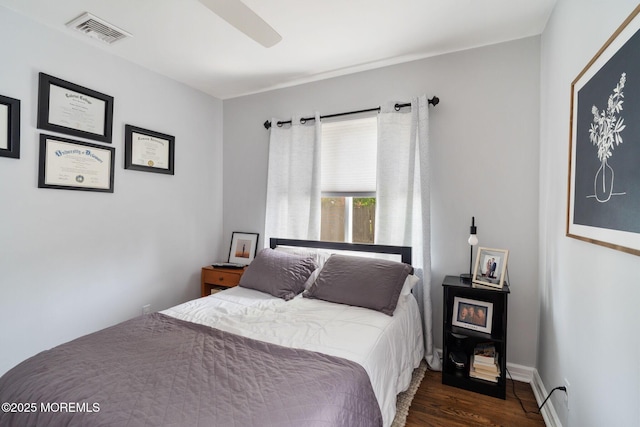 bedroom with ceiling fan, dark wood-style floors, and visible vents