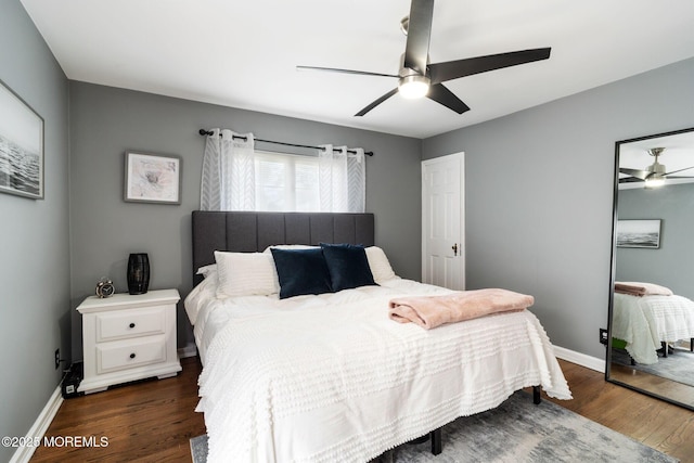 bedroom featuring baseboards, ceiling fan, and wood finished floors