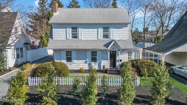 191 State Route 35, Red Bank, NJ 07701 - view of front facade with fence private yard, roof with shingles, a chimney, and a carport