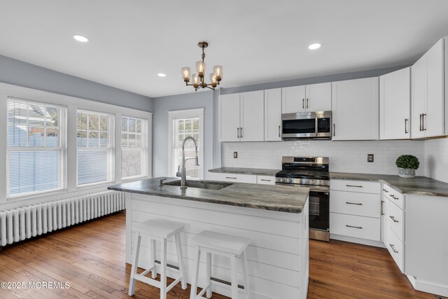 191 State Route 35, Red Bank, NJ 07701 - kitchen featuring a notable chandelier, appliances with stainless steel finishes, a sink, radiator, and tasteful backsplash