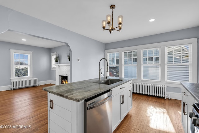 191 State Route 35, Red Bank, NJ 07701 - kitchen with stainless steel dishwasher, a sink, radiator heating unit, and wood-type flooring