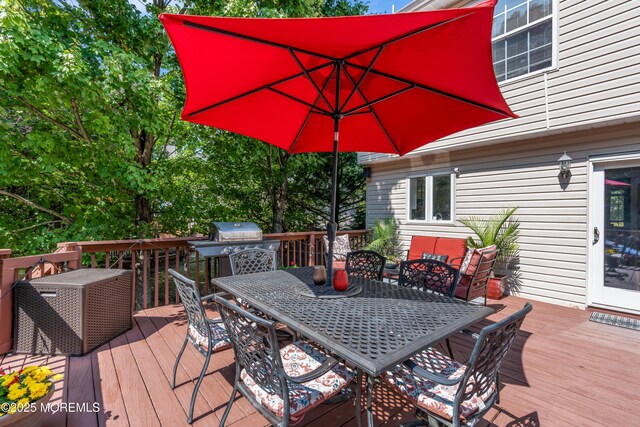 wooden terrace featuring outdoor dining space