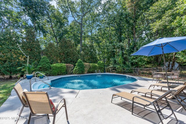 outdoor pool featuring a patio area and fence