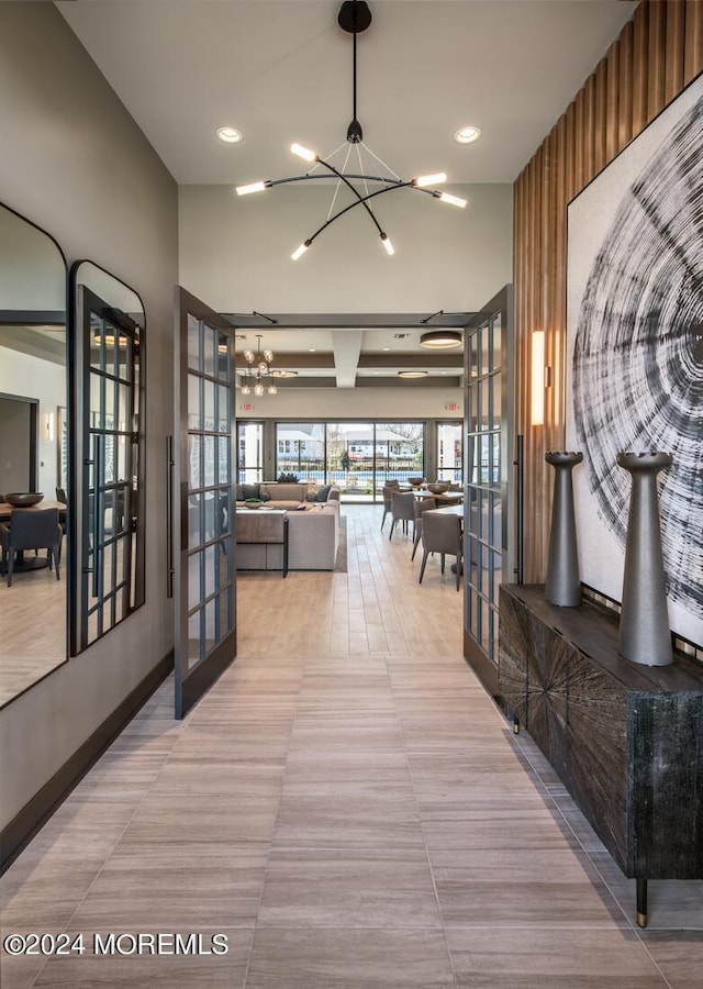 103 Wisteria Ct, Freehold, NJ 07728 - hallway featuring french doors, tile patterned flooring, beamed ceiling, a chandelier, and recessed lighting