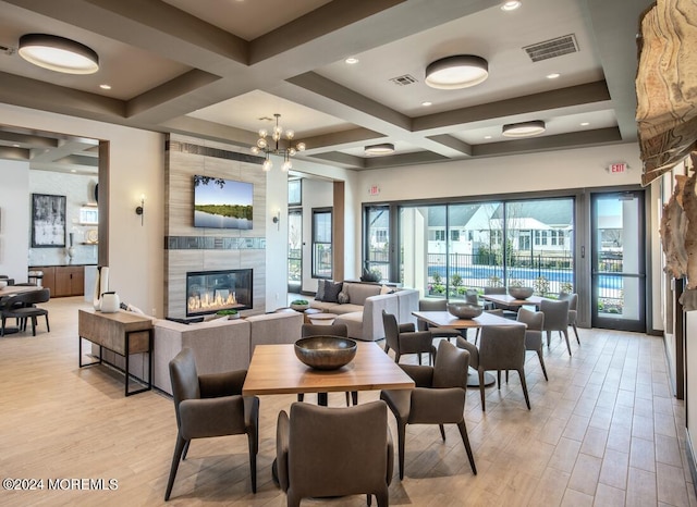 103 Wisteria Ct, Freehold, NJ 07728 - dining room featuring visible vents, a tile fireplace, beamed ceiling, light wood-style floors, and coffered ceiling