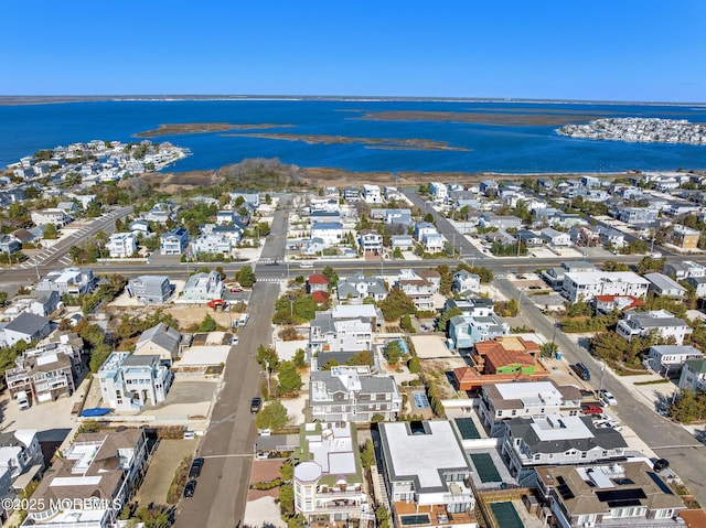 drone / aerial view with a water view and a residential view