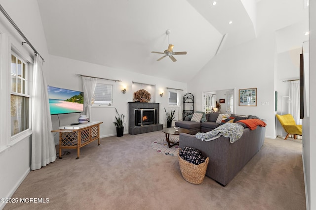 carpeted living room featuring baseboards, high vaulted ceiling, plenty of natural light, and ceiling fan