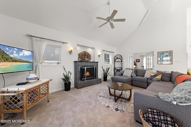 living room featuring plenty of natural light, a ceiling fan, a fireplace, high vaulted ceiling, and carpet