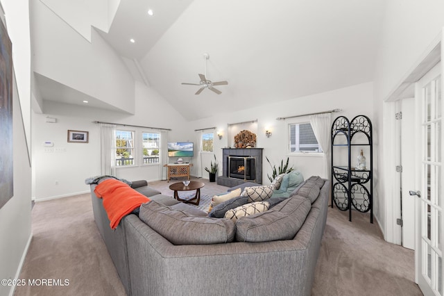 carpeted living area featuring a ceiling fan, a tile fireplace, high vaulted ceiling, baseboards, and recessed lighting