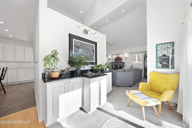 interior space featuring recessed lighting, a sink, and high vaulted ceiling