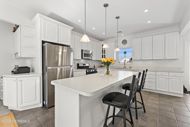 kitchen featuring white cabinets, stainless steel appliances, open shelves, and a sink