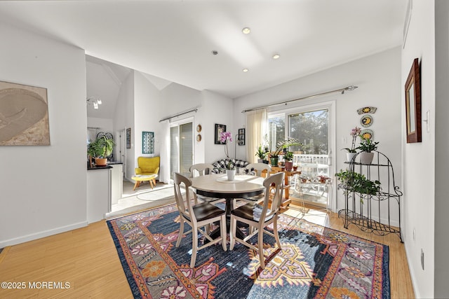 dining space with light wood-style floors, baseboards, vaulted ceiling, and recessed lighting