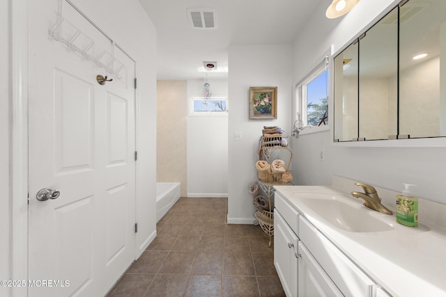 bathroom featuring vanity, baseboards, tile patterned flooring, and visible vents