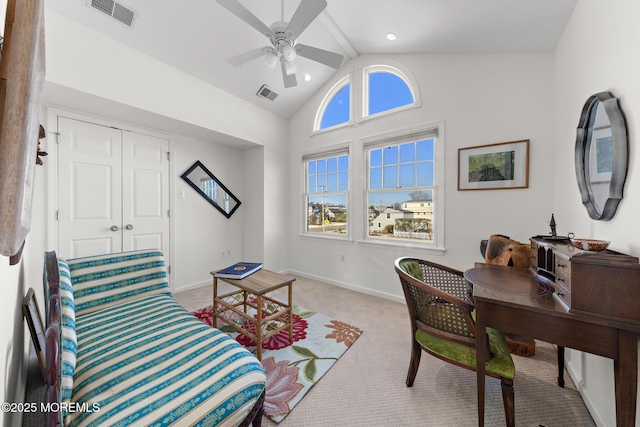 interior space featuring visible vents, a ceiling fan, vaulted ceiling, and light carpet