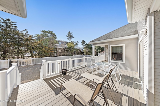 wooden terrace with outdoor dining space