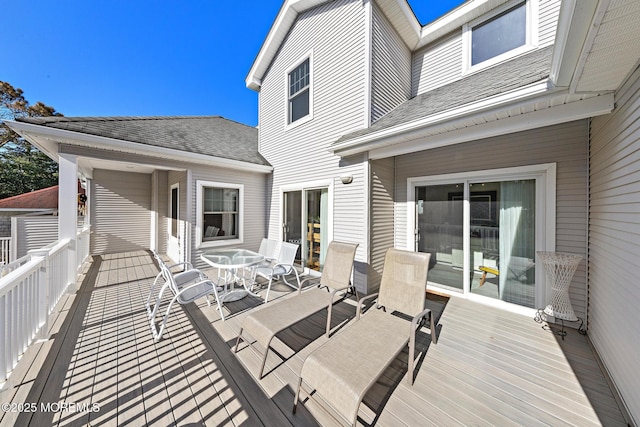 wooden terrace with outdoor dining space