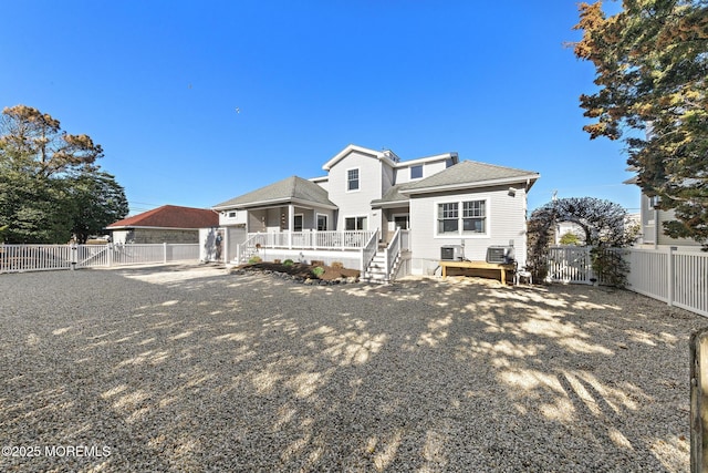 back of property with a gate, a fenced backyard, and a wooden deck