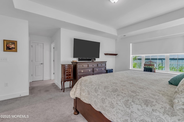 bedroom featuring baseboards and light carpet