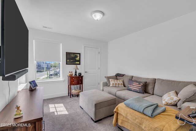 living area featuring baseboards, carpet flooring, and visible vents