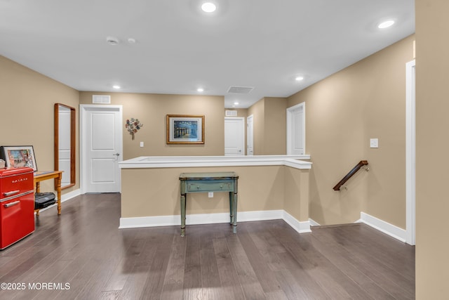 interior space featuring baseboards, dark wood-type flooring, recessed lighting, and visible vents