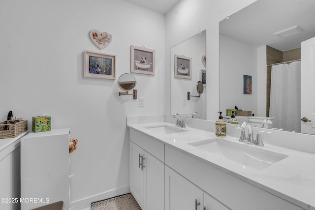 bathroom with double vanity, baseboards, a sink, and a shower with curtain