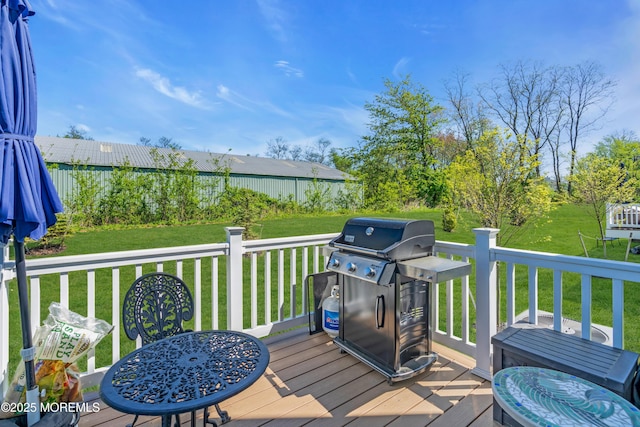 wooden deck featuring a lawn and area for grilling