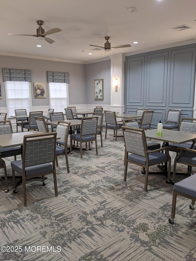 dining room with recessed lighting, ceiling fan, a decorative wall, crown molding, and light carpet