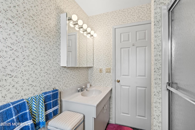 bathroom featuring vanity and wallpapered walls