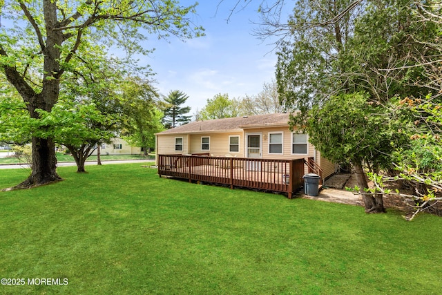 back of house with a yard and a deck