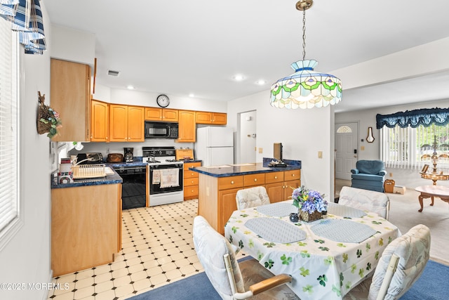 kitchen featuring visible vents, dark countertops, open floor plan, recessed lighting, and black appliances