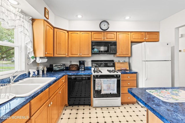 kitchen with dark countertops, a sink, light floors, a toaster, and black appliances