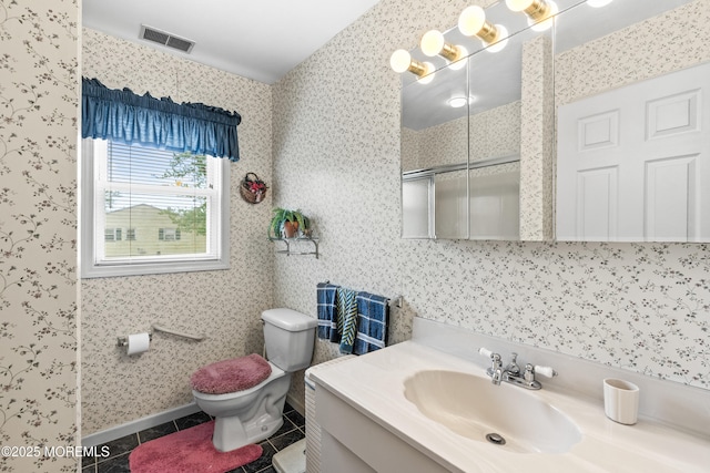 full bathroom with visible vents, vanity, toilet, tile patterned floors, and a shower with shower door