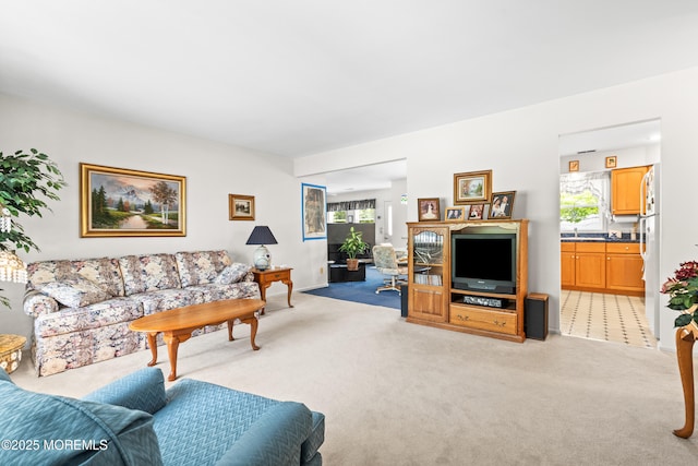 living area featuring light colored carpet