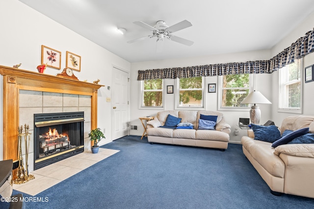 carpeted living area featuring a tiled fireplace, ceiling fan, and visible vents