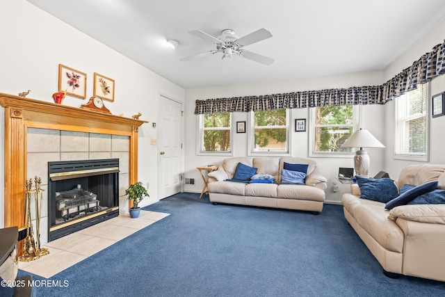 living room with ceiling fan, carpet flooring, a tile fireplace, and visible vents